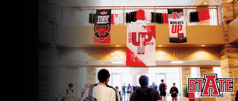 Students walk under Wolves Up flags in Reng Student Union