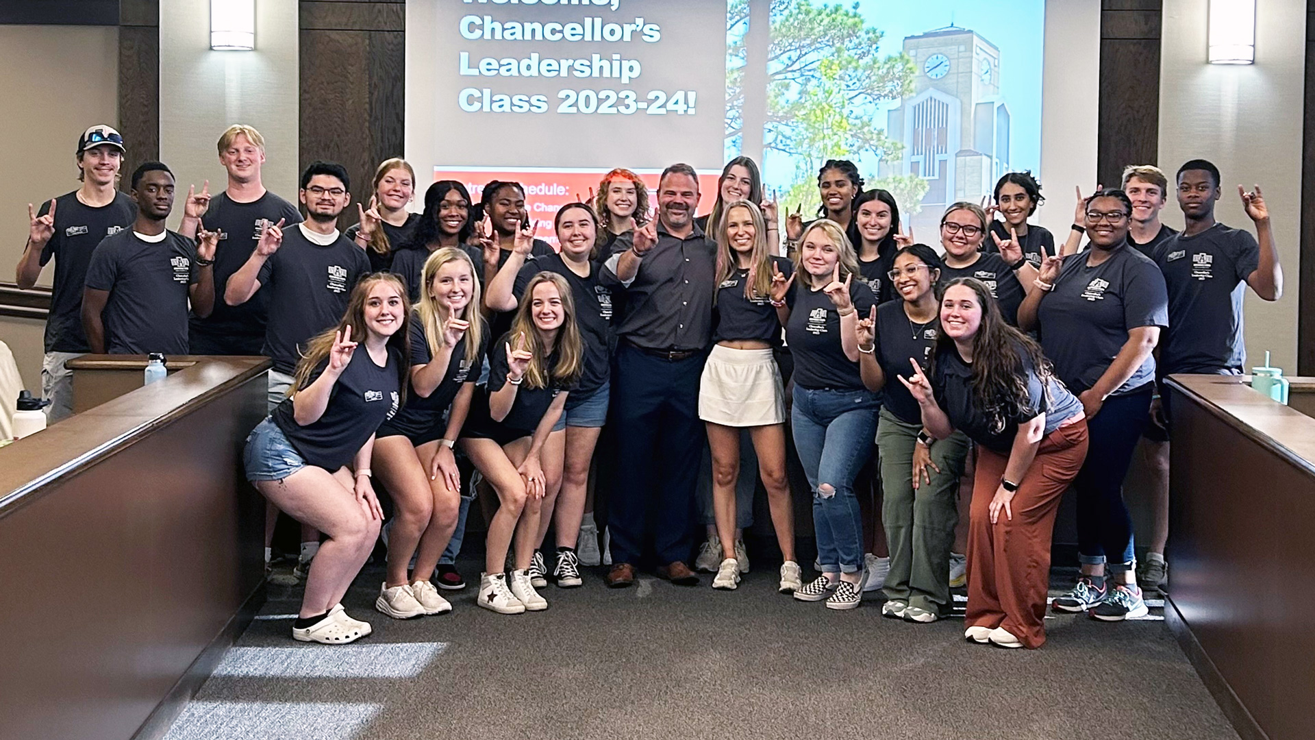 A group photo of the Emerging Scholars doing a Wolves Up hand gesture