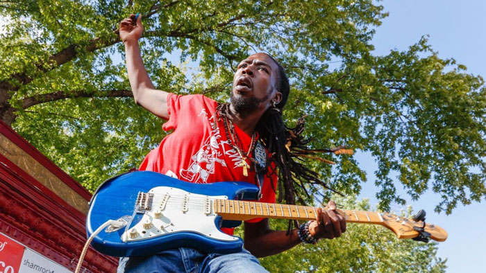 Musician Akeem Kemp with a guitar