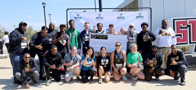 Alpha Phi Alpha Inc. fraternity members pose with winners of the inaugural Alphas for Autism 5K