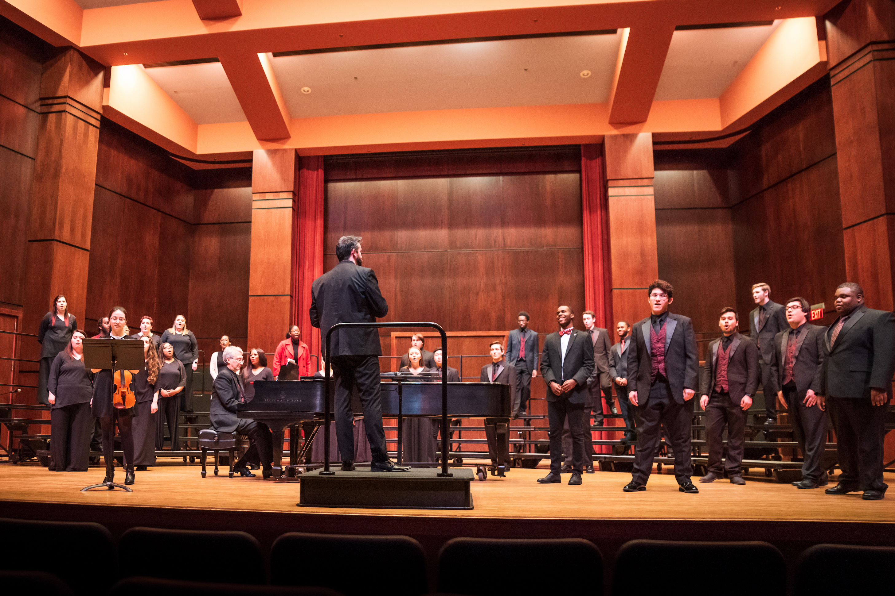 Choirs on the Riceland stage with a violinist and a pianist