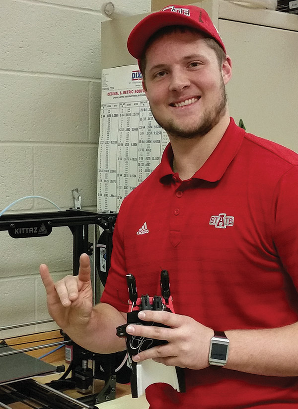 Kenny Rains holding his 3D printed hand.