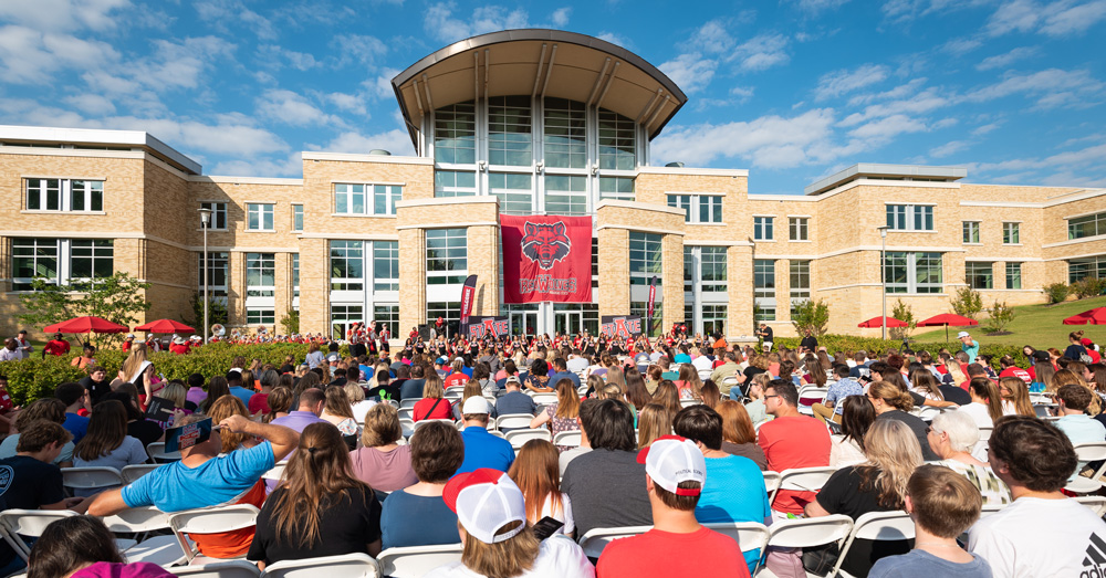 Students sitting in front of the Student Union